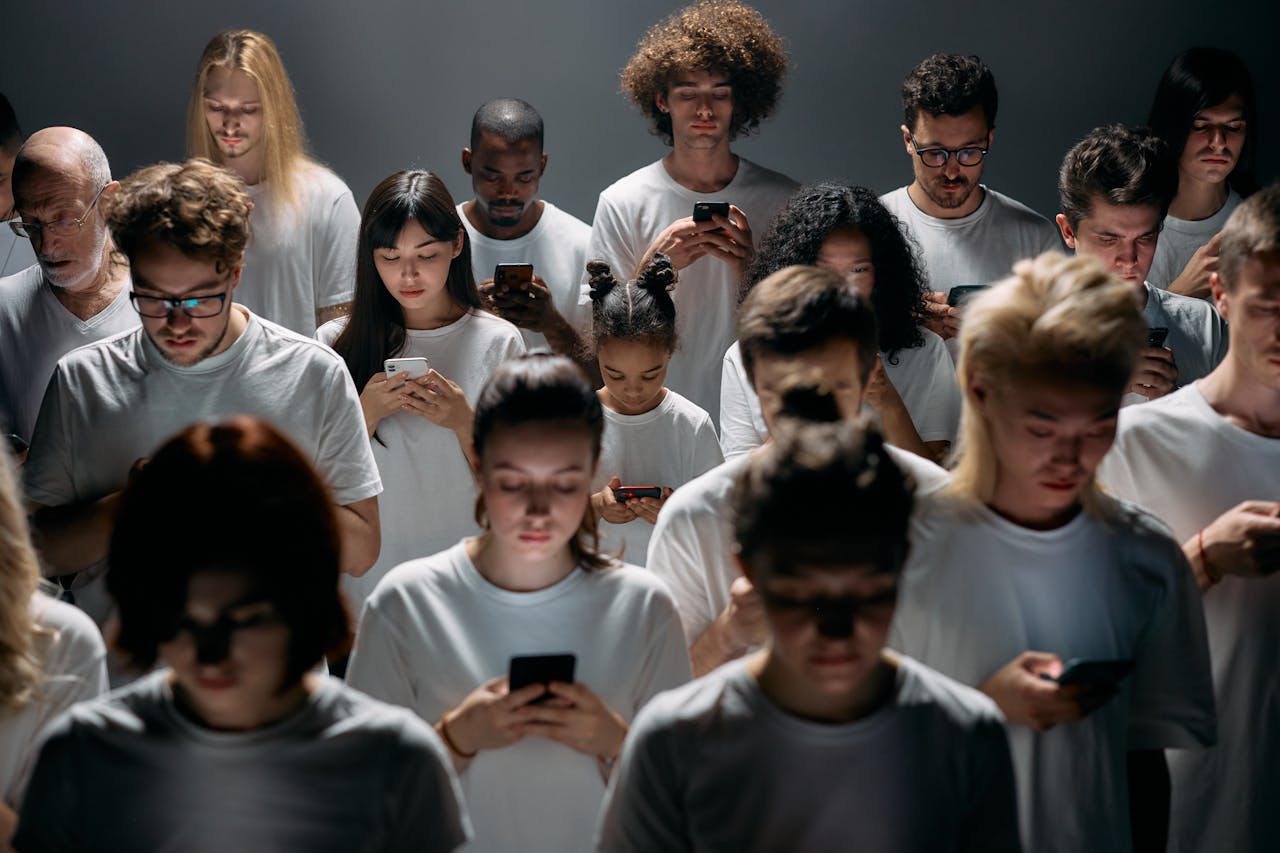 Mastering the First Impression: Your intriguing post title goes here A diverse crowd of people using smartphones, highlighting modern social connections and isolation.