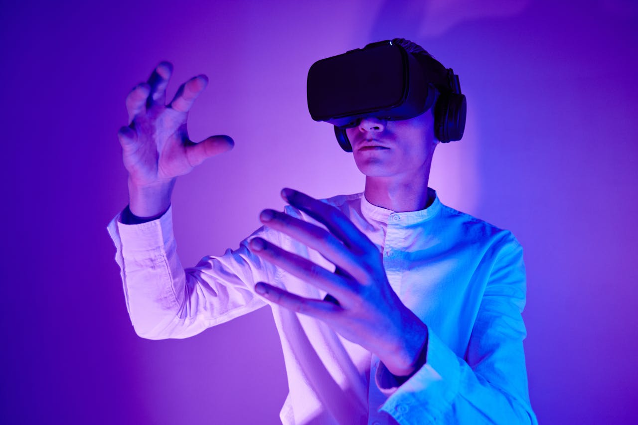 projects-header A man wearing VR goggles interacts with a virtual environment in a studio shot with vibrant lighting.